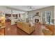Bright living room featuring hardwood floors, a fireplace, and an open layout to the kitchen at 205 Forbes Rd, Wake Forest, NC 27587
