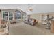 Bright living room featuring a ceiling fan, carpet flooring, and large windows at 205 Forbes Rd, Wake Forest, NC 27587