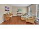 Cozy living room featuring hardwood floors, neutral paint, comfortable seating, and natural light at 205 Forbes Rd, Wake Forest, NC 27587
