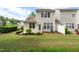 Backyard with patio, garden beds, green lawn, and trees at 207 Bell Tower Way, Morrisville, NC 27560