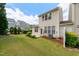 Well-maintained backyard with green lawn, patio, and mature landscaping at 207 Bell Tower Way, Morrisville, NC 27560