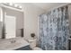 Well-lit bathroom with a modern sink and shower with patterned curtain at 207 Bell Tower Way, Morrisville, NC 27560