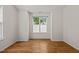 Bedroom with wood floor and large window providing great natural light at 207 Bell Tower Way, Morrisville, NC 27560