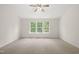 Large bedroom with ceiling fan and multiple windows providing ample natural light at 207 Bell Tower Way, Morrisville, NC 27560