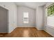 Cozy bedroom featuring neutral paint, window, and wood floors at 207 Bell Tower Way, Morrisville, NC 27560