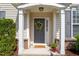 Welcoming front porch features decorative wreath, 'Hello Sunshine' mat, and seasonal decor at 207 Bell Tower Way, Morrisville, NC 27560