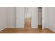 Hallway showcasing wood floors, doors, and natural light at 207 Bell Tower Way, Morrisville, NC 27560