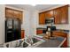 Well-lit kitchen featuring stainless steel appliances, dark countertops, and ample cabinetry at 207 Bell Tower Way, Morrisville, NC 27560