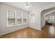 Bright living room features wood floors, large windows, and a ceiling fan at 207 Bell Tower Way, Morrisville, NC 27560