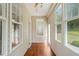 Enclosed sunroom with wood floors and multiple windows at 207 Bell Tower Way, Morrisville, NC 27560