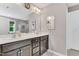 Bathroom featuring a double sink vanity with gray cabinets and a large mirror at 208 Gillean Ln, Holly Springs, NC 27540