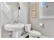 Powder room featuring pedestal sink, neutral paint and matching decor at 208 Gillean Ln, Holly Springs, NC 27540