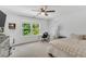 Bright bedroom featuring a ceiling fan, large window, and desk space at 208 Gillean Ln, Holly Springs, NC 27540