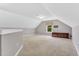 Expansive bonus room featuring neutral paint, carpeting, and a charming window at 208 Gillean Ln, Holly Springs, NC 27540