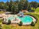 Aerial view of the community pool with waterslide, seating and fenced-in area at 208 Gillean Ln, Holly Springs, NC 27540
