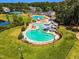 Aerial view of the community pool with waterslide, seating and fenced-in area at 208 Gillean Ln, Holly Springs, NC 27540