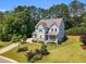 Beautiful two-story home with a well-manicured lawn and charming curb appeal at 208 Gillean Ln, Holly Springs, NC 27540