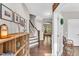 Elegant foyer with hardwood floors, staircase, and views into the living spaces at 208 Gillean Ln, Holly Springs, NC 27540