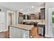 Gourmet kitchen with a center island, granite countertops, and stainless steel appliances at 208 Gillean Ln, Holly Springs, NC 27540