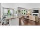 Open concept living room with hardwood floors, fireplace, and seamless transition to breakfast nook at 208 Gillean Ln, Holly Springs, NC 27540