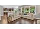 Bright and airy living room with large sectional sofa and view of the backyard at 208 Gillean Ln, Holly Springs, NC 27540