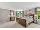 Serene primary bedroom with large bed, dresser, and side tables at 208 Gillean Ln, Holly Springs, NC 27540