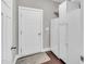 Clean mud room featuring tile floors, a door to the garage, and storage at 208 Gillean Ln, Holly Springs, NC 27540