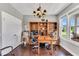 Well-lit home office featuring hardwood floors, large windows, and built-in bookcases at 208 Gillean Ln, Holly Springs, NC 27540
