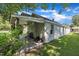 Exterior view of the home showcasing a covered patio and a well-maintained yard at 215 N 4Th St, Smithfield, NC 27577
