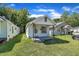 Quaint home with decorative iron porch, green lawn, and tree-lined street at 215 N 4Th St, Smithfield, NC 27577