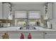 Bright kitchen featuring white cabinets, double sink and windows at 215 N 4Th St, Smithfield, NC 27577