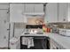 Functional kitchen with white cabinets, tile backsplash, and essential appliances at 215 N 4Th St, Smithfield, NC 27577