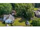 Aerial view of a property with a home, shed, mature trees, and spacious green lawn at 2240 Delaney Dr, Burlington, NC 27215