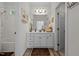 Bright bathroom featuring a white vanity with a sink, storage, and neutral walls and floors at 2240 Delaney Dr, Burlington, NC 27215
