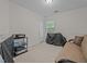 A standard-sized bedroom with a neutral carpet and walls, a window, and basic furniture at 2240 Delaney Dr, Burlington, NC 27215