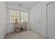 A standard-sized bedroom with a neutral carpet and walls, a window, and a side table at 2240 Delaney Dr, Burlington, NC 27215