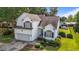 Charming two-story home featuring a manicured lawn, attached garage, and inviting curb appeal at 2240 Delaney Dr, Burlington, NC 27215