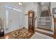 Inviting foyer featuring hardwood floors, a grandfather clock, and a staircase with a safety gate at 2240 Delaney Dr, Burlington, NC 27215