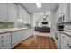Spacious kitchen open to the living room, featuring white cabinets and modern appliances at 2240 Delaney Dr, Burlington, NC 27215