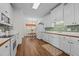 Charming kitchen with white cabinets, wood countertops, and a cozy dining area at 2240 Delaney Dr, Burlington, NC 27215