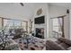 Spacious living room featuring a fireplace, large windows, and comfortable seating arrangements at 2240 Delaney Dr, Burlington, NC 27215