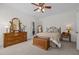 Inviting bedroom with a wooden dresser and chest, complemented by a comfortable bed at 2240 Delaney Dr, Burlington, NC 27215