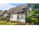 Rear view of a home with a well-maintained lawn and landscaped shrubs and bushes at 2240 Delaney Dr, Burlington, NC 27215