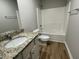 A modern bathroom with granite countertops and a tub-shower combination at 235 Starry Sky Dr, Benson, NC 27504
