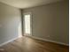 Bedroom featuring wood-look flooring and a glass panel door to the outdoors at 235 Starry Sky Dr, Benson, NC 27504