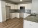 Bright kitchen with white cabinets, granite countertops and stainless steel appliances at 235 Starry Sky Dr, Benson, NC 27504
