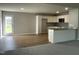 Open-concept kitchen with stainless steel appliances, an eat-in island and adjacent living area at 235 Starry Sky Dr, Benson, NC 27504