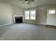 Bright living room featuring a corner fireplace, neutral carpet, and a ceiling fan at 235 Starry Sky Dr, Benson, NC 27504