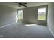 Sunlit main bedroom with plush neutral carpet and large windows offering a view of the outdoors at 235 Starry Sky Dr, Benson, NC 27504