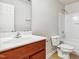 Bright bathroom featuring a wooden vanity, a toilet and a white bathtub at 2523 Ferdinand Dr, Knightdale, NC 27545